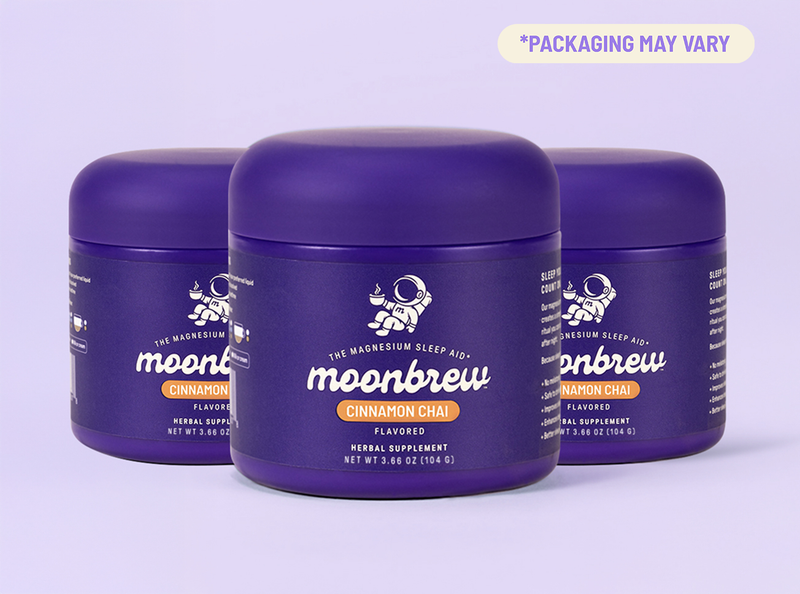 Front view of three MoonBrew Cinnamon Chai tubs showcasing purple packaging and label logo with pale lavender background