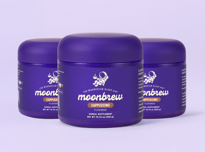 Three-quarter front view of three MoonBrew Cappuccino tubs showing purple label, and 10.74 oz net weight on a lavender background