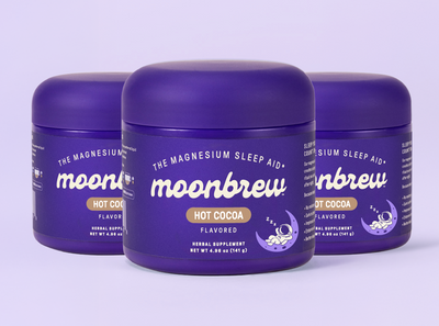 Front view of three Moonbrew Hot Cocoa jars labeled The Magnesium Sleep Aid on a pale purple background