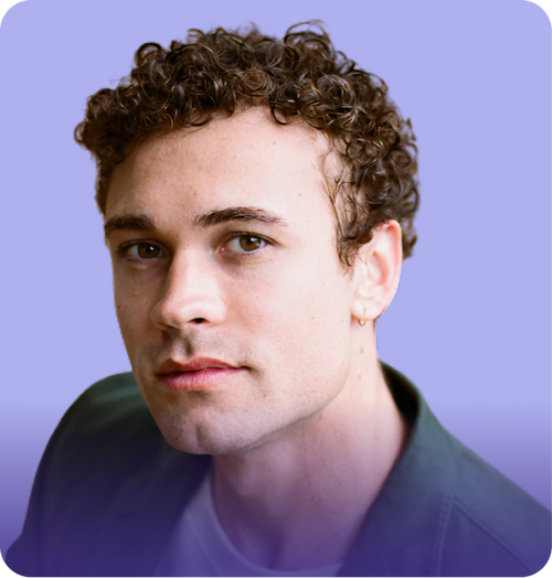 Headshot of a clinician with curly brown hair looking at the camera against a purple gradient background