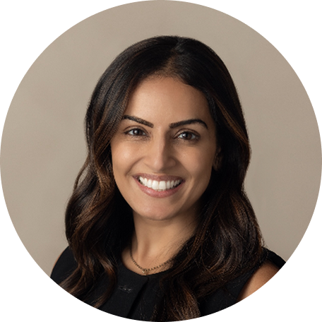 Female clinician smiling in a circular professional headshot with a neutral beige background