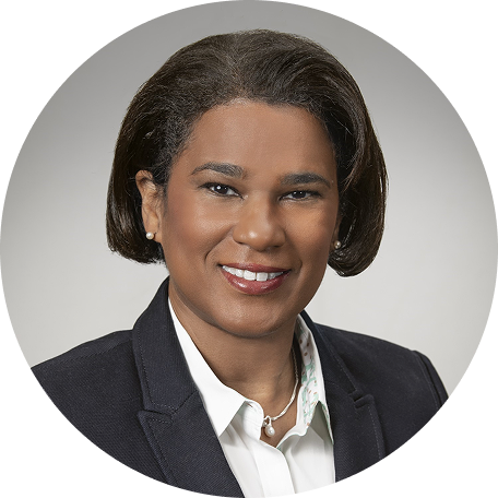 Dr. Charlene Gamaldo smiling in a professional circular headshot with gray background