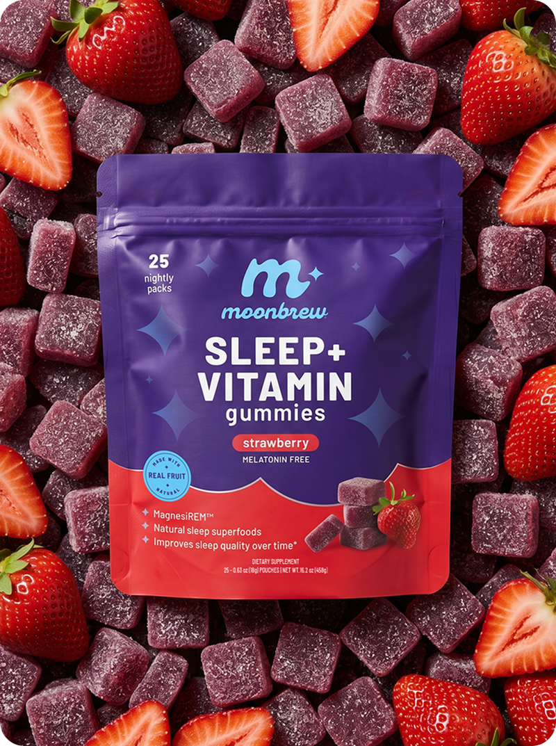 Front view of MoonBrew Sleep and Vitamin gummies pouch, strawberry flavor, with scattered gummies and strawberries background