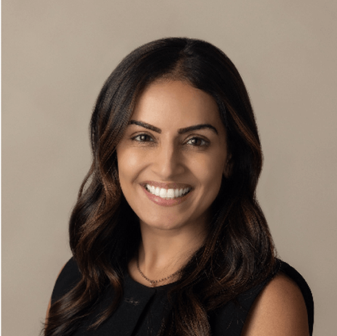 Smiling longevity cardiologist (Dr. Timsie Malaney) headshot on a neutral beige background