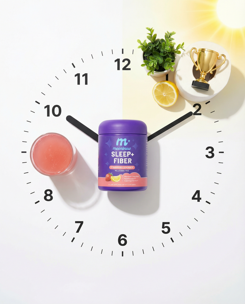 Front view of MoonBrew Sleep Plus Fiber powder, Strawberry Lemonade, showing Sleep Plus Fiber and Melatonin Free label on a clock-face background with a glass and lemon